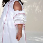 Picture of White And Fuchsia Piping With Shoulder Cut Dress For Girls